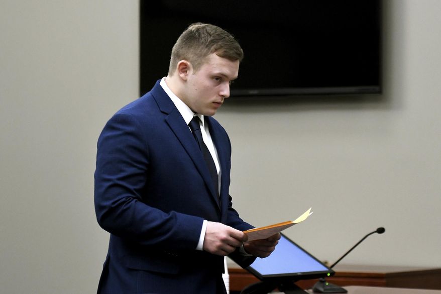In this Thursday, March 29, 2018 photo, Damian Walker leaves court during a pretrial hearing in Ingham County Circuit Court, in Lansing, Mich. Walker, charged following a threat that prompted Lansing Community College to evacuate in November, pleaded guilty to making a false report or threat of terrorism. (Nick King/Lansing State Journal via AP)