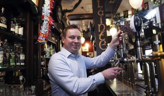 Brian Conlon, publican of Slattery&#39;s Bar on Capel Street in Dublin, pulls a pint on Good Friday, Friday March 30, 2018. Drinking establishments are open and serving alcohol _ thanks to recently legislation that overturned a ban in place since 1927 and took effect in the nick of time for thirsty locals and tourists. (Brian Lawless/PA via AP)