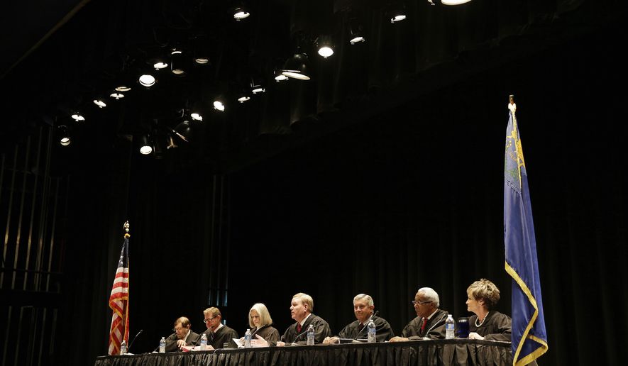 FILE- In this Oct. 8, 2014, file photo, the Supreme Court of Nevada prepares to hear arguments at Palo Verde High School in Las Vegas. A public employee's personal devices are open to public inspection under the state's public records laws, the state Supreme Court unanimously ruled on Thursday, March 29, 2018. (AP Photo/John Locher, File)