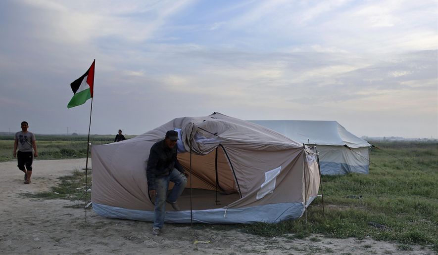 Palestinians are setting up tents in preparation for mass demonstrations along the Gaza strip border with Israel, in eastern Gaza City, Tuesday, March 27, 2018. Gaza’s embattled Hamas rulers are imploring hundreds of thousands of people to march along the border with Israel in the coming weeks -- a high risk gambit meant to shore up their shaky rule, but with potentially deadly consequences. (AP Photo/Adel Hana)