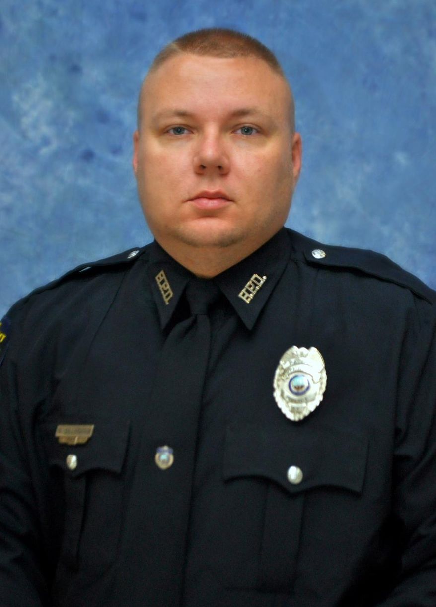 This photo provided by the Kentucky State Police shows  Officer Phillip Meacham. The off-duty police officer was shot and killed Thursday, March 29, 2018, in  Hopkinsville, Ky., and authorities were searching for a suspect who fled in a stolen truck, Kentucky State Police said. (Kentucky State Police via AP)