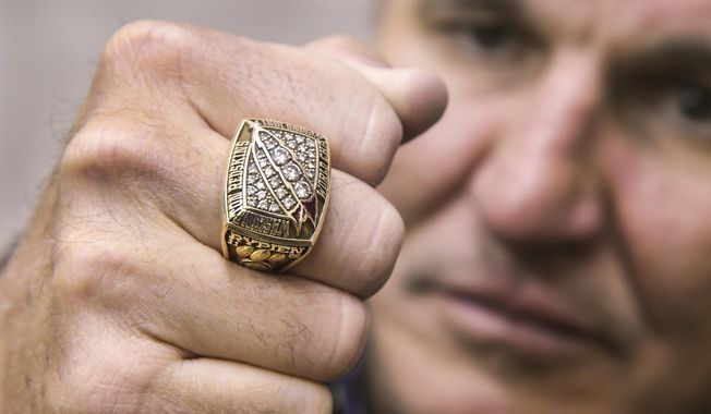 In this Monday, March 26, 2018 photo, former Super Bowl MVP Mark Rypien displays his Super Bowl ring in Spokane, Wash. Rypien said he has attempted suicide, hired prostitutes and suffers from persistent depression, and wonders if he suffered brain injuries while playing football. (Dan Pelle /The Spokesman-Review via AP)