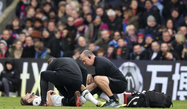 Liverpool&#x27;s Adam Lallana lays injured on the pitch during the English Premier League soccer match between Crystal Palace and Liverpool, at Selhurst Park, in London, Saturday March 31, 2018. (Adam Davy/PA via AP)