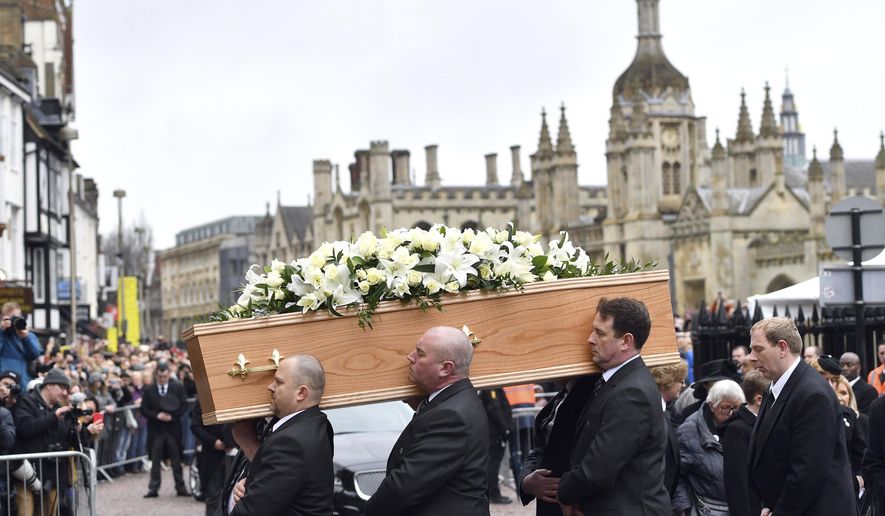 The coffin of Professor Stephen Hawking arrives at University Church of St Mary the Great as mourners gather to pay their respects, in Cambridge, England, Saturday March 31, 2018. The renowned British physicist died peacefully on March 14 at the age of 76. (Joe Giddens/PA via AP)