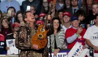 FILE - In this Nov. 7, 2016 file photo, musician Ted Nugent performs before Republican presidential candidate Donald Trump comes on stage for his campaign rally before the general election, in the Grand Gallery at DeVos Place in Grand Rapids, Mich.   Nugent says the Florida students calling for gun control have “no soul” and are “mushy brained children.” He made the comments Friday while defending the National Rifle Association as a guest on the Joe Pags Show, a nationally syndicated conservative radio program. Nugent, an NRA board member, said survivors of the Parkland school shooting are wrong to blame the NRA for mass shootings.(Joel Bissell/The Grand Rapids Press via AP, File)