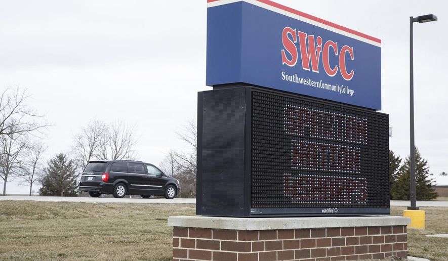 Cars enter Southwester Community College for memorial services for Kevin Sharp, his wife, Amy Sharp, and their children, Sterling and Adrianna on Saturday, March 31, 2018, in Creston, Iowa. The family were found dead while on vacation in Mexico. A Mexican prosecutor says a gas leak in a water heater is suspected of killing them inside their rented condominium in Tulum. Their bodies were found Friday. (Brian Powers/The Des Moines Register via AP)