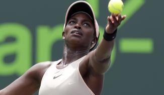 Sloane Stephens serves to Jelena Ostapenko, of Latvia, during the final at the Miami Open tennis tournament, Saturday, March 31, 2018, in Key Biscayne, Fla. (AP Photo/Lynne Sladky)