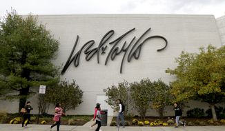 People walk on a sidewalk along the entrance to Lord &amp; Taylor department store at Garden State Plaza, Wednesday, Oct. 25, 2017, in Paramus, N.J. (AP Photo/Julio Cortez)