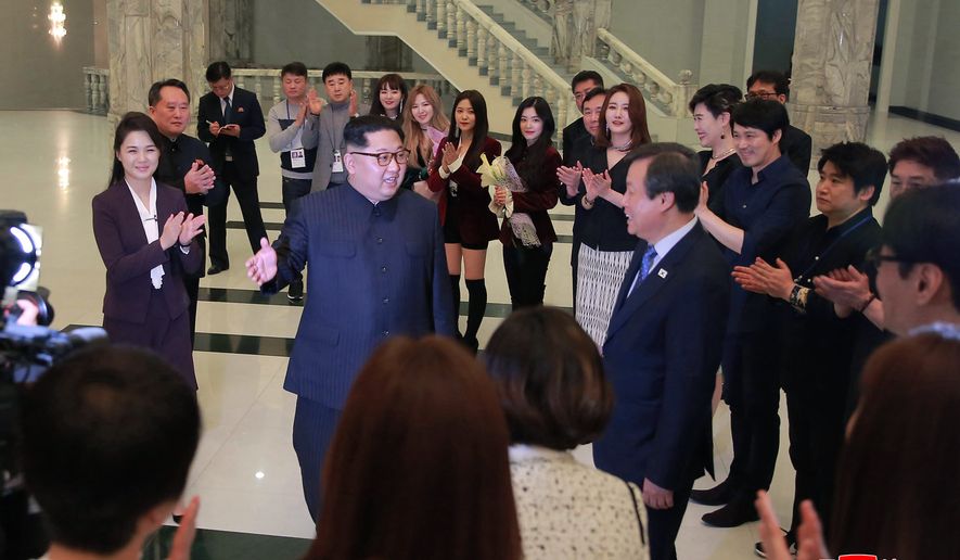 In this photo provided by the North Korean government, North Korean leader Kim Jong Un, center left, talks with South Korean Culture, Sports and Tourism Minister Do Jong-whan, center right, as his wife Ri Sol Ju, left, claps during a visit to members of a South Korean artistic group after their performance in Pyongyang, North Korea, Sunday, April 1, 2018. Kim clapped his hands as he, along with his wife and hundreds of other citizens, watched the rare performance Sunday by South Korean pop stars visiting Pyongyang, highlighting the thawing ties between the rivals after years of heightened tensions over the North&#39;s nuclear program. Independent journalists were not given access to cover the event depicted in this image distributed by the North Korean government. The content of this image is as provided and cannot be independently verified. Korean language watermark on image as provided by source reads: &quot;KCNA&quot; which is the abbreviation for Korean Central News Agency.  (Korean Central News Agency/Korea News Service via AP)