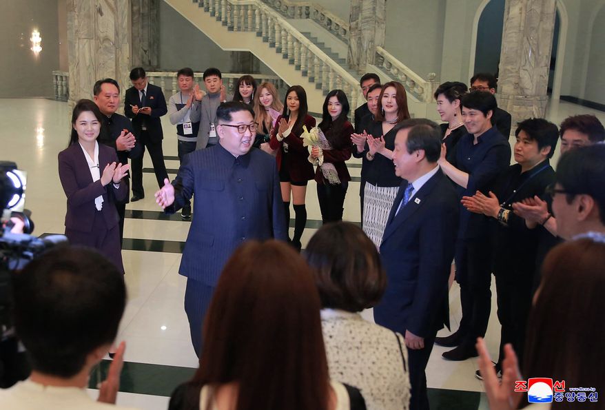 In this photo provided by the North Korean government, North Korean leader Kim Jong Un, center left, talks with South Korean Culture, Sports and Tourism Minister Do Jong-whan, center right, as his wife Ri Sol Ju, left, claps during a visit to members of a South Korean artistic group after their performance in Pyongyang, North Korea, Sunday, April 1, 2018. Kim clapped his hands as he, along with his wife and hundreds of other citizens, watched the rare performance Sunday by South Korean pop stars visiting Pyongyang, highlighting the thawing ties between the rivals after years of heightened tensions over the North&#x27;s nuclear program. Independent journalists were not given access to cover the event depicted in this image distributed by the North Korean government. The content of this image is as provided and cannot be independently verified. Korean language watermark on image as provided by source reads: &quot;KCNA&quot; which is the abbreviation for Korean Central News Agency.  (Korean Central News Agency/Korea News Service via AP)