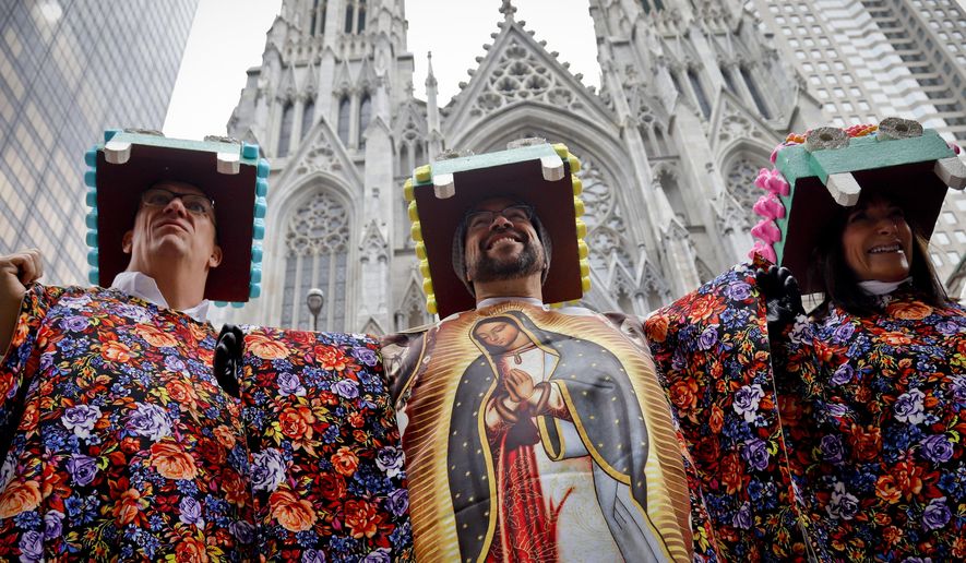 Friends and neighbors Robert Brinkman, left, Mario Gomez, center, and Randy Honig, right, themed themselves as the "Virgin of Guadalupe," attend Easter celebrations along Fifth Avenue, Sunday April 1, 2018, in New York. The event, more of a promenade than a parade, is a take on a New York City tradition that dates back to the late 1800s. In those days, the city's richer residents would wear their best clothes and walk along after attending church services. (AP Photo/Bebeto Matthews)