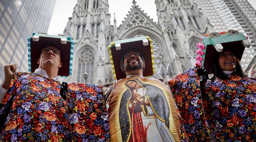 Friends and neighbors Robert Brinkman, left, Mario Gomez, center, and Randy Honig, right, themed themselves as the "Virgin of Guadalupe," attend Easter celebrations along Fifth Avenue, Sunday April 1, 2018, in New York. The event, more of a promenade than a parade, is a take on a New York City tradition that dates back to the late 1800s. In those days, the city's richer residents would wear their best clothes and walk along after attending church services. (AP Photo/Bebeto Matthews)