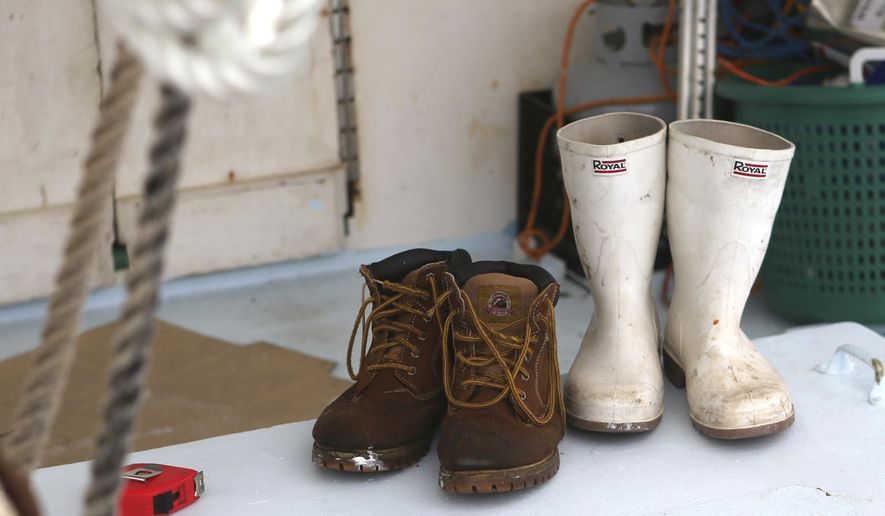 This photo taken Jan. 22, 2018, shows Carl Roby's boots on the deck of the Cynthia Renee at the St.Andrews Marina in Panama City, Fla. Roby has been fishing for decades. He started as a teenager in the 1970s when regulations weren't as confining, spending summers working on charter boats out of Captain Anderson's Marina. He liked it, and eventually he moved on to bigger fish, yellowfin tuna. (Patti Blake/News Herald via AP)