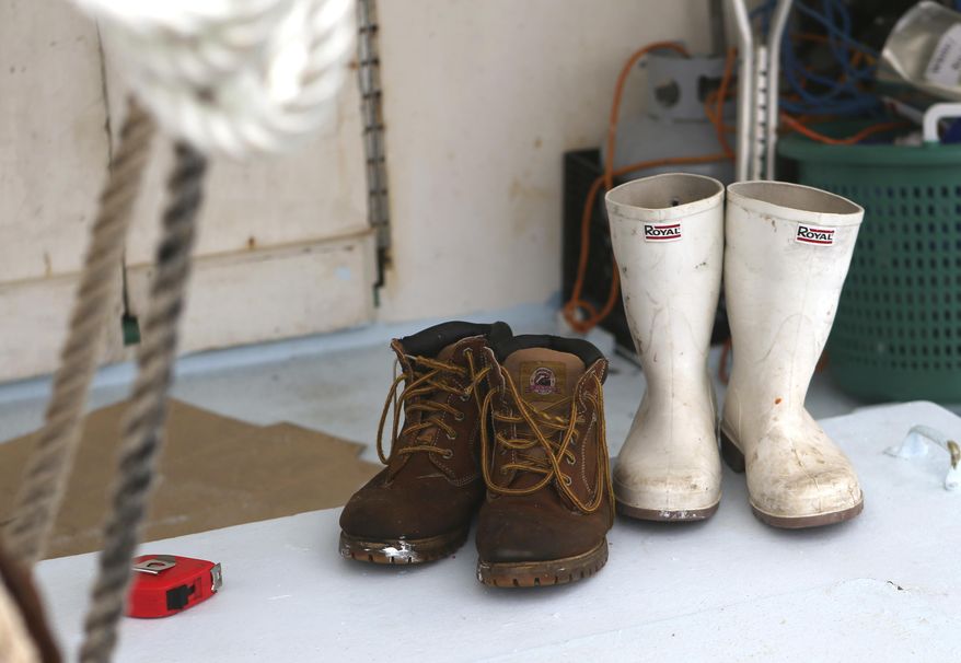 This photo taken Jan. 22, 2018, shows Carl Roby's boots on the deck of the Cynthia Renee at the St.Andrews Marina in Panama City, Fla. Roby has been fishing for decades. He started as a teenager in the 1970s when regulations weren't as confining, spending summers working on charter boats out of Captain Anderson's Marina. He liked it, and eventually he moved on to bigger fish, yellowfin tuna. (Patti Blake/News Herald via AP)