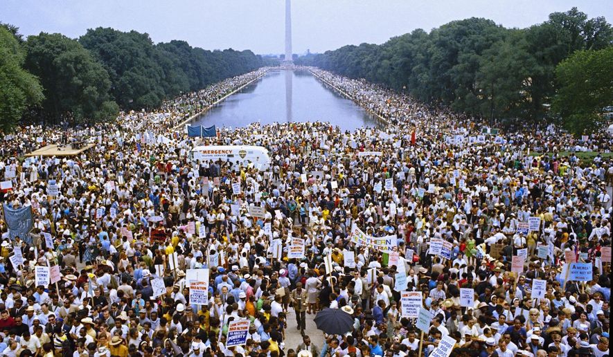 FILE - In this June 19, 1968 file photo, demonstrators march on Washington during the Poor Peoples' Campaign Solidarity Day. From the civil rights protests of the 1960s to the marriage equality movement, civil disobedience has taken on different forms in the years since Martin Luther King, Jr. was assassinated. (AP Photo/Charles Tasnadi, File)