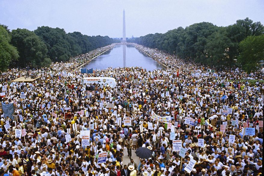 FILE - In this June 19, 1968 file photo, demonstrators march on Washington during the Poor Peoples&#39; Campaign Solidarity Day. From the civil rights protests of the 1960s to the marriage equality movement, civil disobedience has taken on different forms in the years since Martin Luther King, Jr. was assassinated. (AP Photo/Charles Tasnadi, File)