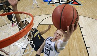 Villanova&#x27;s Donte DiVincenzo (10) goes up for a shot past Michigan&#x27;s Charles Matthews (1) during the second half in the championship game of the Final Four NCAA college basketball tournament, Monday, April 2, 2018, in San Antonio. (AP Photo/Chris Steppig, NCAA Photos Pool)