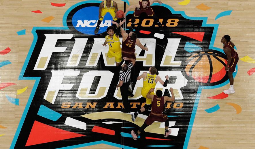 Michigan's Isaiah Livers (4) and Loyola-Chicago's Cameron Krutwig (25) battle for the ball at the tip off during the first half in the semifinals of the Final Four NCAA college basketball tournament, Saturday, March 31, 2018, in San Antonio. (AP Photo/Morry Gash)