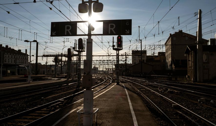 FILE - In this file photo dated Thursday, March 22, 2018, an empty train platform is pictured during a railway strike at the Lyon Perrache train station, central France. France's national train company SNCF said in a statement Sunday April 1, 2018, warning that a workers' strike will disrupt train service within France and elsewhere in Europe on upcoming Tuesday and Wednesday. (AP Photo/Laurent Cipriani, FILE)
