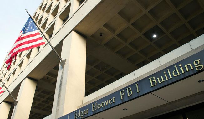 In this Nov. 2, 2016, file photo, the FBI&#x27;s J. Edgar Hoover headquarter building in Washington. (AP Photo/Cliff Owen, File)  **FILE**