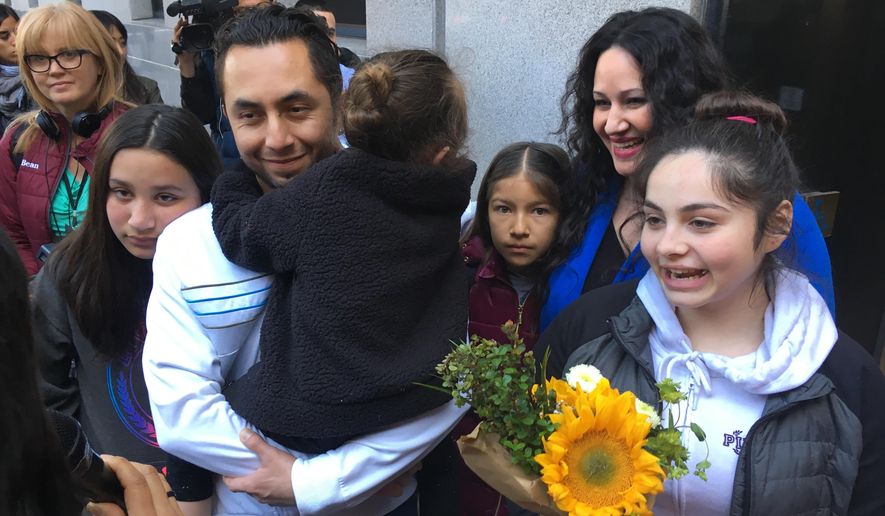 Fernando Carrillo stands with his family and talks with reporters after walking out of a U.S. immigration office Monday, April 2, 2018, in San Francisco. Carrillo, who was arrested by immigration officials after dropping off his daughter at day care in California, has been released from a detention center and will be allowed to remain in the U.S. (AP Photo/Haven Daley)