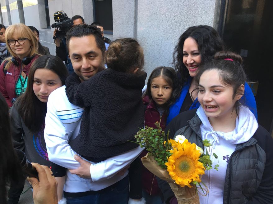 Fernando Carrillo stands with his family and talks with reporters after walking out of a U.S. immigration office Monday, April 2, 2018, in San Francisco. Carrillo, who was arrested by immigration officials after dropping off his daughter at day care in California, has been released from a detention center and will be allowed to remain in the U.S. (AP Photo/Haven Daley)