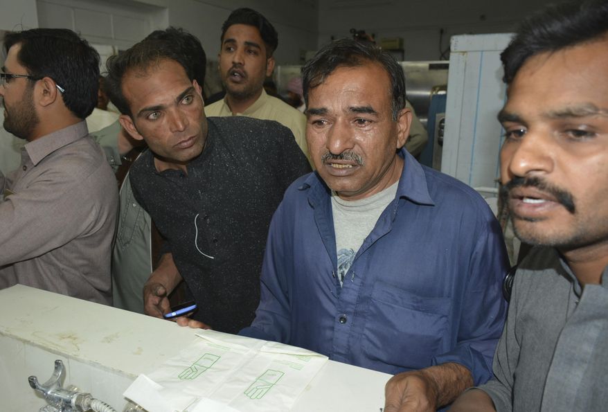 People from the Pakistani Christian community visit a hospital looking for family members, in Quetta, Pakistan, Monday, April 2, 2018. Gunmen riding on motorcycles in two separate attacks hours apart killed four minority Christians from the same family and five Muslims in the northwestern city of Quetta before fleeing on Monday, police said. (AP Photo/Arshad Butt)