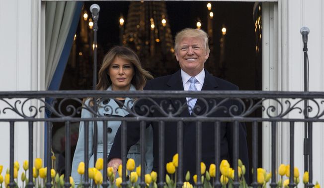 President Donald Trump and first lady Melania Trump arrives on the Truman Balcony of the White House in Washington, Monday, April 2, 2018, for the annual White House Easter Egg Roll. (AP Photo/Carolyn Kaster)