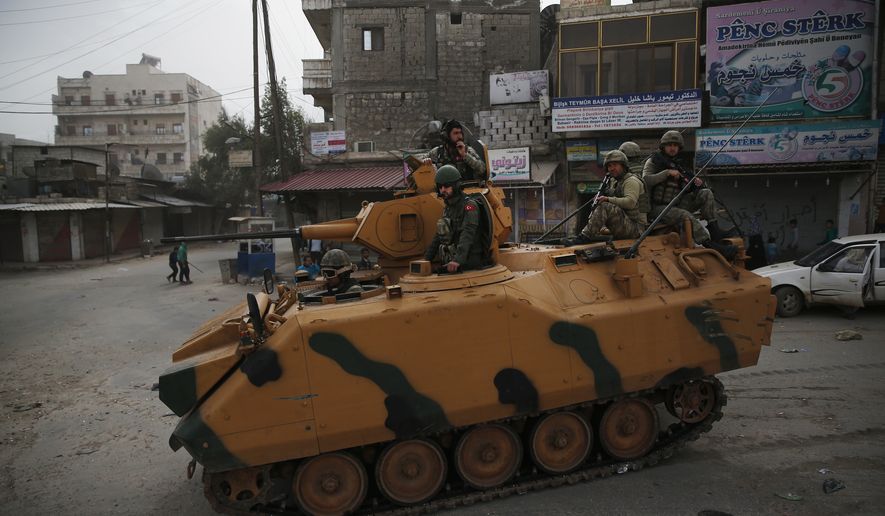 Turkish soldiers atop an armored personnel carrier patrol the northwestern city of Afrin, Syria, during a Turkish government-organized media tour into northern Syria, Saturday, March 24, 2018. (AP Photo/Lefteris Pitarakis) ** FILE **