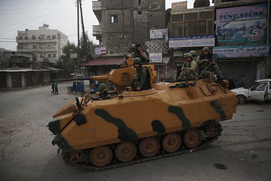 Turkish soldiers atop an armored personnel carrier patrol the northwestern city of Afrin, Syria, during a Turkish government-organized media tour into northern Syria, Saturday, March 24, 2018. (AP Photo/Lefteris Pitarakis) ** FILE **