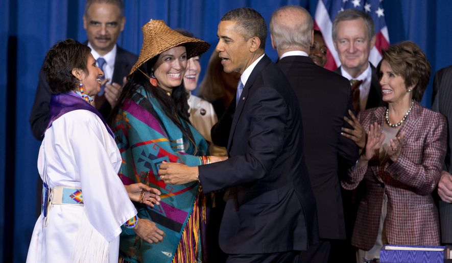 FILE - In this March 7, 2013, file photo, President Barack Obama greets Our Sisterís Keeper Executive Director Diane Millich, from left, and Tulalip Tribes of Washington State Vice Chairwoman Deborah Parker, after signing the Violence Against Women Act in Washington, D.C. Five years after a federal law gave tribes authority over non-Natives for some domestic violence crimes, public safety advocates say communities are empowered to report wrongdoing and governments are working better together. (AP Photo/Manuel Balce Ceneta, File)