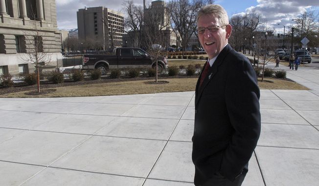 In this photo taken Monday, Jan. 30, 2012, Rep. Bob Nonini, R-Coeur d'Alene, walks toward the Idaho Capitol in Boise on Monday, Jan. 30, 2012. After another Republican representative quit smoking last year, Nonini is the lone open smoker in the Idaho Legislature, a dramatic change from a quarter century ago when lawmakers smoked in caucus meetings and even during hearings on the floor of the House. (AP Photo/John Miller)