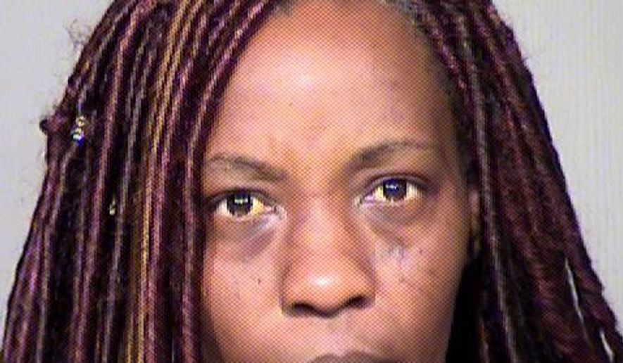 This undated booking photo provided by the Maricopa County Sheriff shows Sharron Dobbins who was arrested on suspicion of child abuse Sunday, April 1, 2018, after her 17-year-old son alerted authorities. Authorities say the Phoenix woman shocked her teenage son with a stun gun to wake him for church services on Easter. According to police documents, the teen did not complain of any pain but told police he had two small bumps on his leg where he was shocked. (Maricopa County Sheriff via AP)