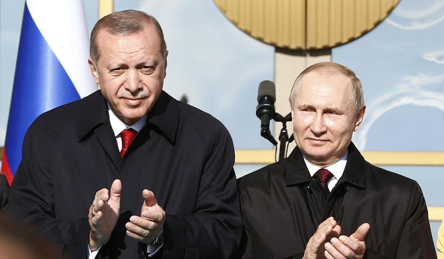 Turkey&#x27;s President Recep Tayyip Erdogan left, and Russia&#x27;s President Vladimir Putin, right, applaud during a welcome ceremony at the Presidential Palace in Ankara, Turkey, Tuesday, April 3, 2018. Turkey and Russia have put aside their traditional rivalries and differences on regional issues, to forge closer ties. (AP Photo/Burhan Ozbilici) **FILE**