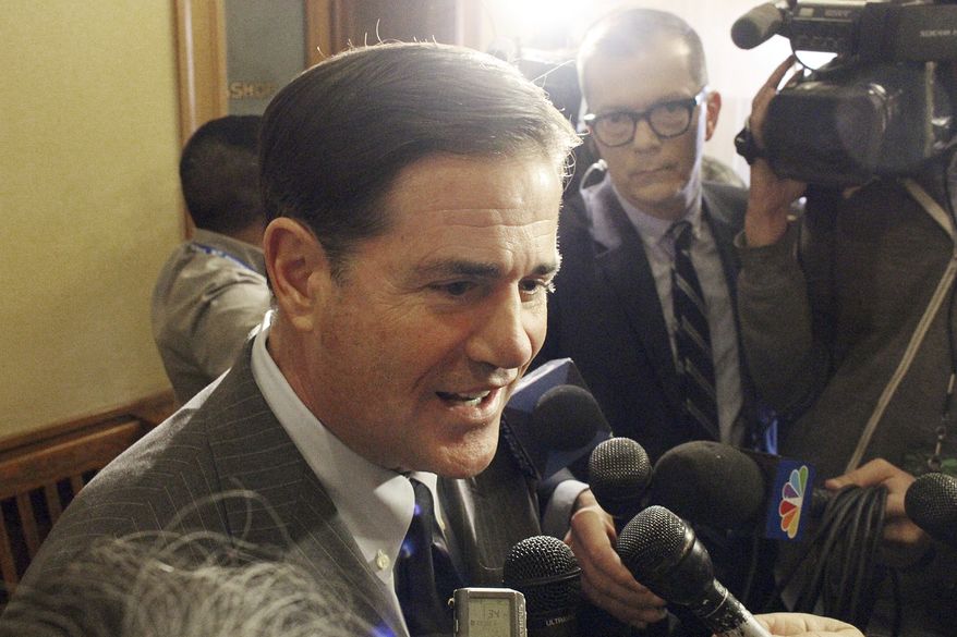 Arizona Gov. Doug Ducey talks to reporters at the state Capitol in Phoenix after signing legislation designed to address the opioid crisis Friday, Jan. 26, 2018. The new law is designed to crack down on opioid abuse and cut the number of overdose deaths. Friday's signing comes after the Legislature unanimously approved the measure the day before to end a four-day special session called by the Republican governor. (AP Photo/Bob Christie)