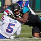 FILE - In this Jan. 7, 2018, file photo, Jacksonville Jaguars defensive end Yannick Ngakoue, right, draws a penalty by hitting Buffalo Bills quarterback Tyrod Taylor (5) with helmet-to-helmet contact in the first half of an NFL wild-card playoff football game, in Jacksonville, Fla. Bob Costas isn’t backing down on his belief that the NFL faces a day of reckoning on the issue of brain injuries, and talks about the one event he wishes he had been able to broadcast on the “AP Sports Weekly” podcast. The NBC and MLB announcer joins co-hosts Jim Litke and Tim Dahlberg to talk about a variety of issues, including the Olympics and how the growing use of analytics has made baseball into a different game than he watched growing up.(AP Photo/Stephen B. Morton, File)
