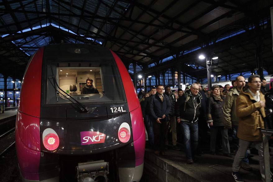 Commuters arrive at Saint-Lazare train station in Paris, Wednesday, April 4, 2018 in the first of a series of strikes that are set to last three months. A major French railway strike has brought the country's famed high-speed trains to a halt, leaving passengers stranded and posing the biggest test so far for President Emmanuel Macron's economic strategy. (AP Photo/Christophe Ena)