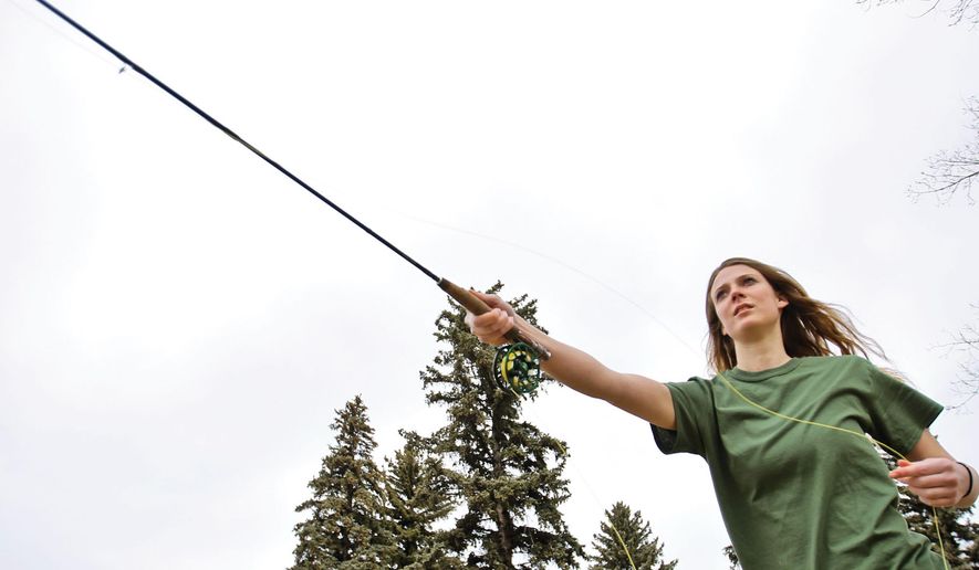 Amy Phillips, vice president of University of Wyoming's Fish N Chicks club, practices casting in Depot Park in Laramie, Wyo., on Saturday, March 24, 2018. (Laramie Boomerang via AP)