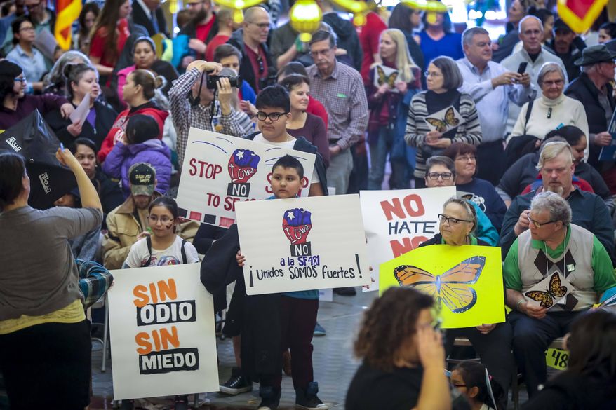 In a Wednesday, March 21, 2018 photo, organizations, individuals and communities from around the state gather at the statehouse to call for state legislators to reject SF481, the anti-immigrant, warrantless detention bill that recently passed a House committee and is now eligible for full House debate. (Rodney White/The Des Moines Register via AP)