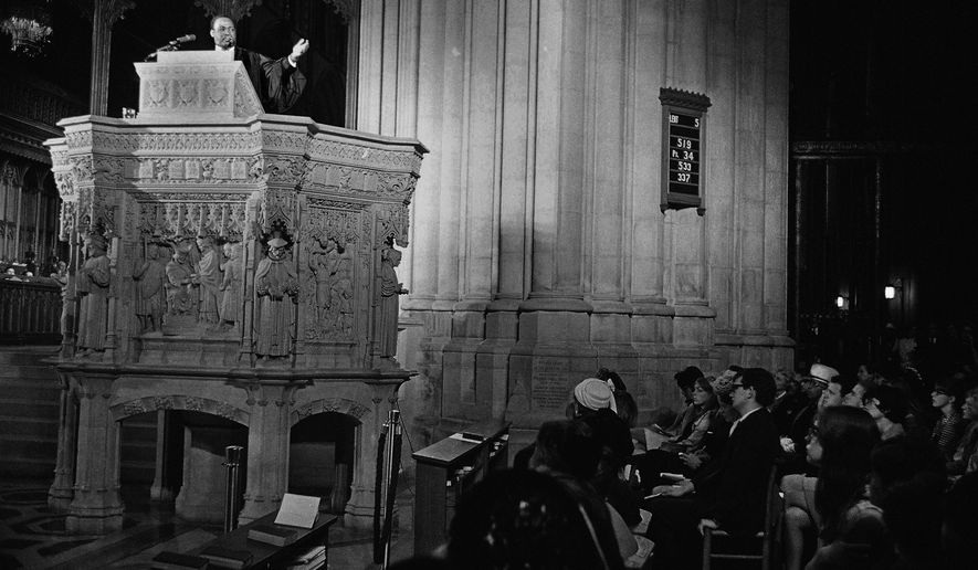 FILE - In this March 31, 1968 file photo, the Rev. Martin Luther King Jr., left, who heads the Southern Christian Leadership Conference, preaches to a capacity crowd from the pulpit at the National Cathedral in Washington. King spoke from the Cathedral&#39;s Canterbury Pulpit. It would be his last Sunday sermon before he was assassinated on April 4, 1968, in Memphis. (AP Photo/John Rous, File)