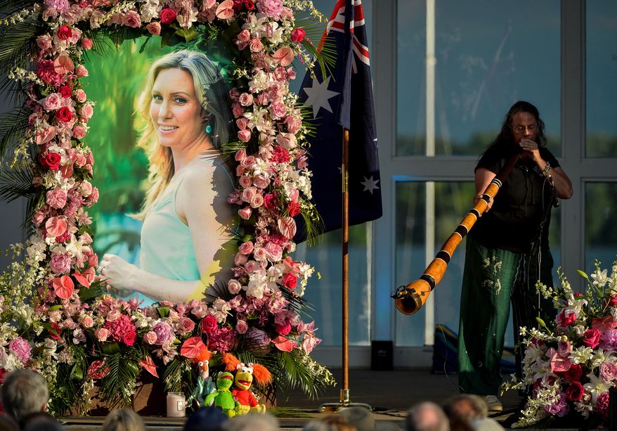 FILE - In this Aug. 11, 2017, file photo, Johanna Morrow plays the didgeridoo during a memorial service for Justine Ruszczyk Damond in Minneapolis. Damond was killed by a Minneapolis police officer on July 15, 2017, after she called 911 to report a possible sexual assault near her home. Police in Minneapolis announced Wednesday, April 4, 2018, new steps to make sure officers use body cameras in the wake of last summer's fatal shooting. (Aaron Lavinsky/Star Tribune via AP, File)