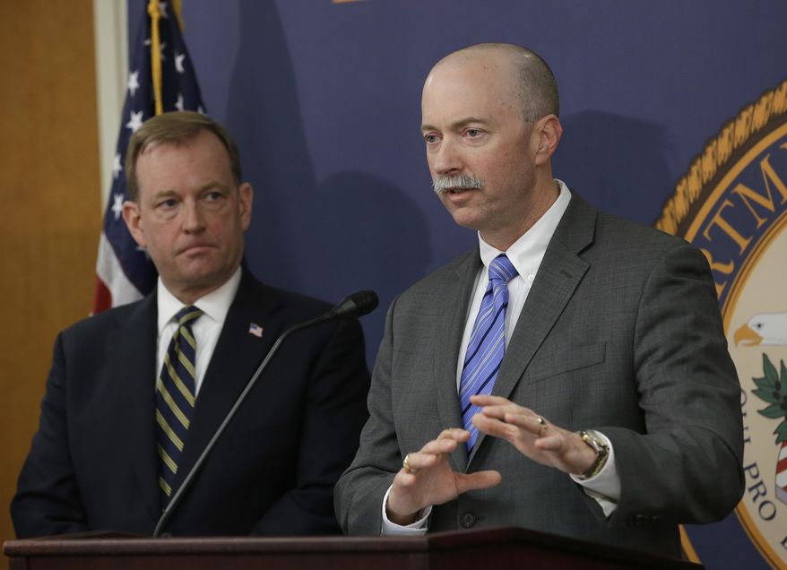 FBI Special Agent in Charge Sean Ragan, right, flanked by McGregor Scott, the United States Attorney For the Eastern District of California, discusses the months-long investigation that led to the law enforcement raids on illegal pot grows in roughly 100 Northern California homes, during a news conference, Wednesday, April 4, 2018, in Sacramento, Calif. The raids, conducted Tuesday and Wednesday in multiple counties, focused on homes purchased with money wired to the United States by a Chinese-based crime organization and used to grow massive amounts of marijuana. (AP Photo/Rich Pedroncelli)