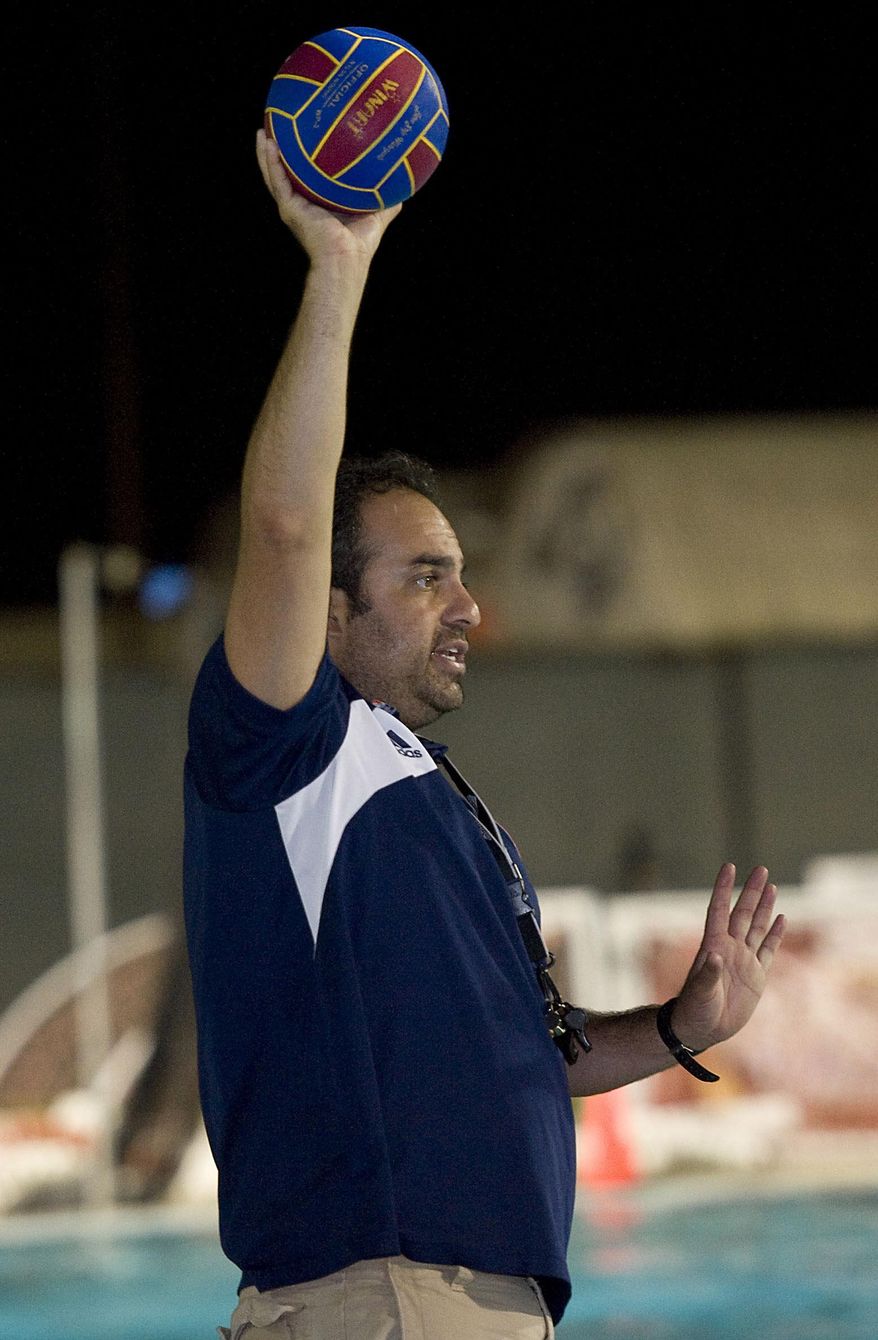 FILE - In this Sept. 23, 2013, file photo, Bahram Hojreh coaches youngsters at at the USA Water Polo National Training Center in Los Alamitos, Calif. Hojreh, who ran a club affiliated with USA Water Polo, has been charged with the sexual abuse of seven underage female players during one-on-one coaching sessions, prosecutors said Wednesday, April 4, 2018. The victims were underage female water polo players and the alleged crimes occurred between 2014 and January of this year, the Orange County district attorney's office said. (Rose Palmisano/The Orange County Register via AP)