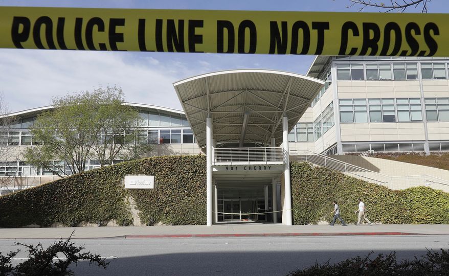 Police tape is shown outside of a YouTube office building in San Bruno, Calif., Wednesday, April 4, 2018. A woman suspected of shooting three people at YouTube headquarters before killing herself was furious with the company because it had stopped paying her for videos she posted on the platform, her father said Tuesday, April 3, 2018. (AP Photo/Jeff Chiu)