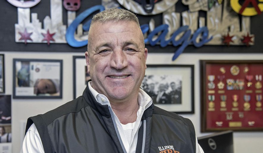 In this March, 21, 2018 photo, Colonel Royal Mortenson who served 30 years in the Marines poses for a photo in Champaign, Ill. His military career included serving as a Marine officer in Operation Enduring Freedom. Mortenson now serves as director of the Illinois Fire Service Institute. (Rick Danzl/The News-Gazette via AP )
