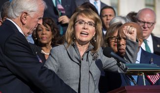 FILE - In this Wednesday, Oct. 4, 2017, file photo, former U.S. Rep. Gabby Giffords, of Arizona, who survived an assassination attempt in 2011, joins other Democrats in a call for action on gun safety legislation on the House steps at the Capitol in Washington. The FBI has released some new photos and video from its investigation of the 2011 shooting in Tucson, Ariz., that left six people dead and 13 injured, including Giffords. (AP Photo/J. Scott Applewhite, File)
