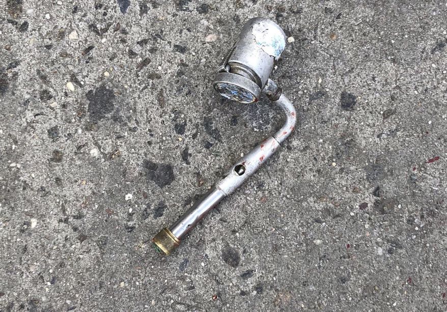 This photo provided by the New York Police Department shows a metal object at the scene where police officers fatally shot a man who was reported to be threatening people with a gun, which turned out to be a metal pipe that police mistook for a firearm, in the Brooklyn borough of New York. Saheed Vassell, 34, was killed Wednesday April 5, 2018, in the Crown Heights neighborhood of Brooklyn. According to The New York Times, police had encountered him before and classified him as emotionally disturbed. (New York Police Department via AP)