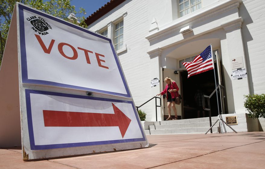 FILE - In this June 14, 2016, file photo, a woman walks out of a polling place after voting in the Nevada primary election in Las Vegas. Nevada's top election official, Secretary of State Barbara Cegavske, says more than 63,000 names were removed from statewide voter registration rolls last month. (AP Photo/John Locher, file) **FILE**