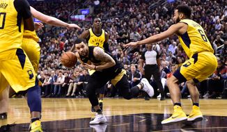 Toronto Raptors guard Fred VanVleet, center, is fouled by Indiana Pacers guard Cory Joseph, right, during first-half NBA basketball game action in Toronto, Friday, April 6, 2018. (Frank Gunn/The Canadian Press via AP)