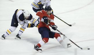 Buffalo Sabres&#39; Josh Gorges (4) and Florida Panthers&#39; Maxim Mamin (78) go for the puck during the second period of an NHL hockey game, Saturday, April 7, 2018, in Sunrise, Fla. (AP Photo/Lynne Sladky)
